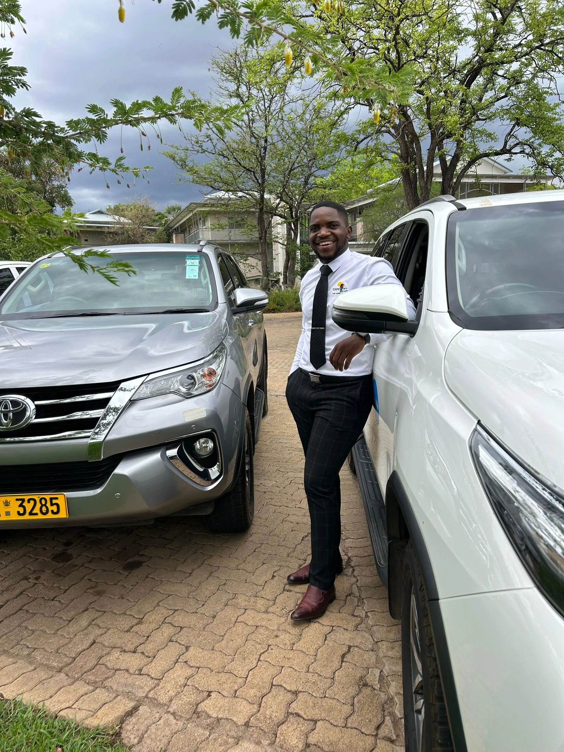 Cape Saints driver welcoming guests beside a Toyota Fortuner